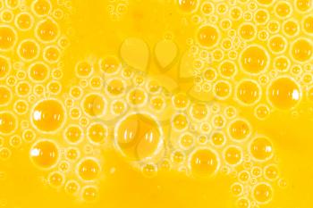 foam on a yellow egg yolk as a background. macro