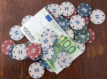 Casino chips and cards, and a hundred euros on the table