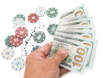 casino chips and cards and one hundred dollars on a white background