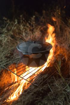 cauldron on fire at night