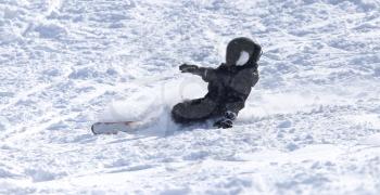 people snowboarding on the snow in the winter