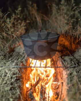 cauldron on fire at night