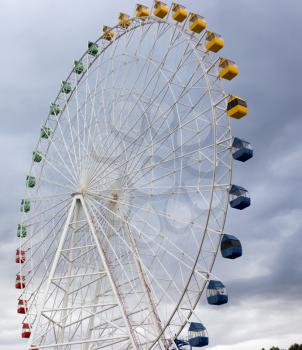 Ferris wheel on the background of clouds