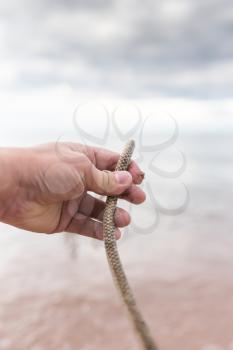 a rope in his hand on a lake