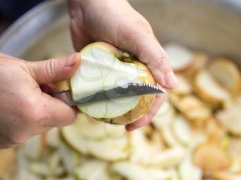 cutting an apple with a knife