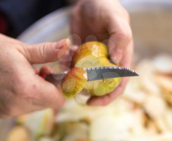 cutting an apple with a knife