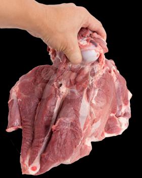 pork meat in hand on a black background