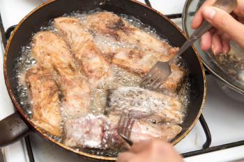 fish is fried in a pan