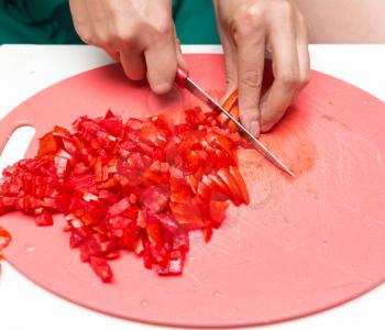 girl cuts a tomato knife