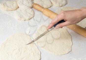 cutting the dough with a knife