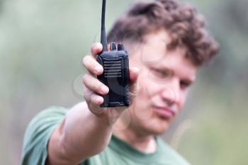 a man with a walkie-talkie outdoors