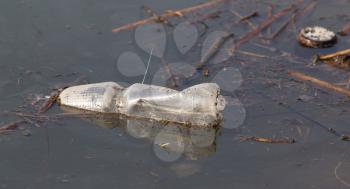 Bottle in the lake as rubbish