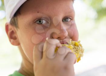 boy eats corn