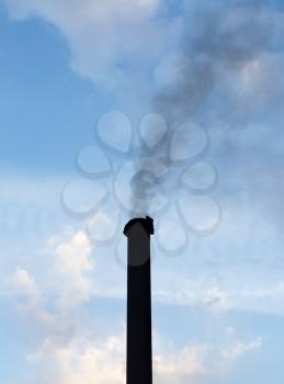 Smoke from a pipe against the sky