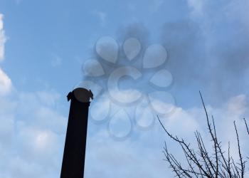 Smoke from a pipe against the sky
