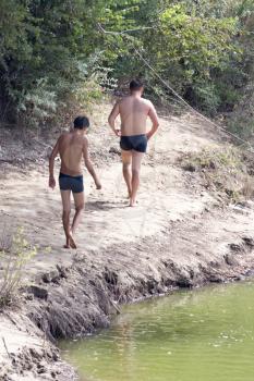 two men on the river swimming