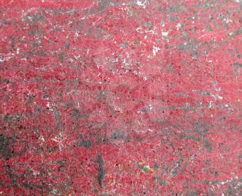 Background of old metal painted red with traces of rust and paint