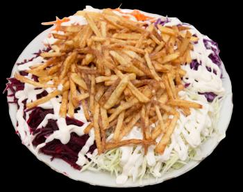 dish of fries with mayonnaise and vegetables on a black background