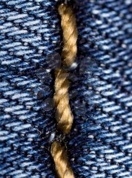 thread on jeans as a background. macro