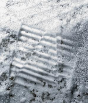 trace of the shoe in the snow as a background