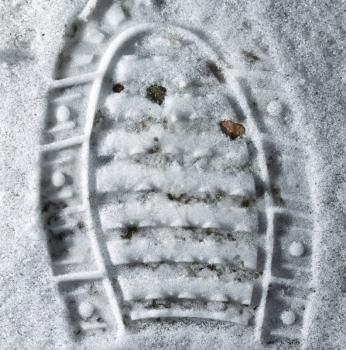 trace of the shoe in the snow as a background