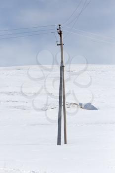 electric pole in the snow in the winter