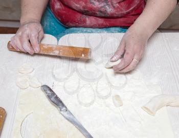 woman unrolls dough at home