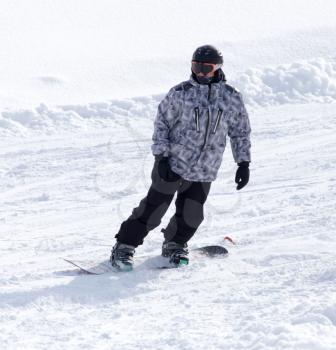 man snowboarding in winter