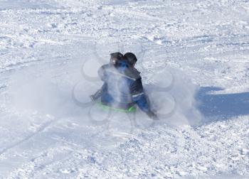 Dad rolls the child on a sled