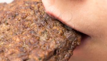 Girl eats burgers from the liver, macro