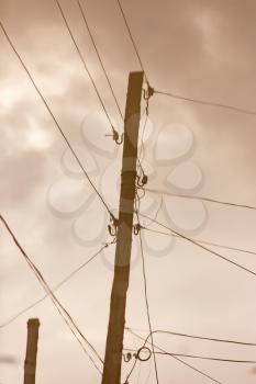 Electric pole reflected in a puddle on the road .