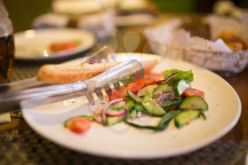 Dish with tomatoes and cucumbers in a restaurant .