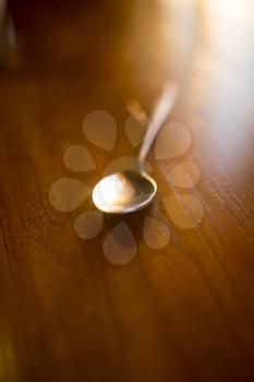 Spoon on the table in the restaurant .