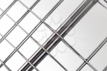 metal mesh on a silver background . A photo