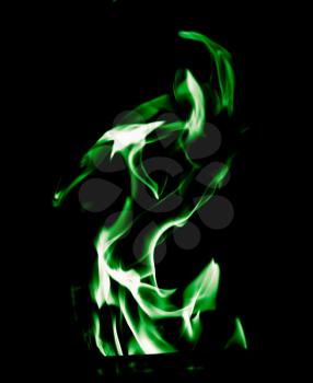 Green flame of fire on a black background .