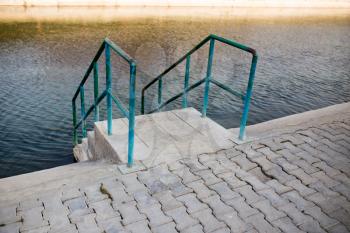 Stairs to the water of the swimming pool .