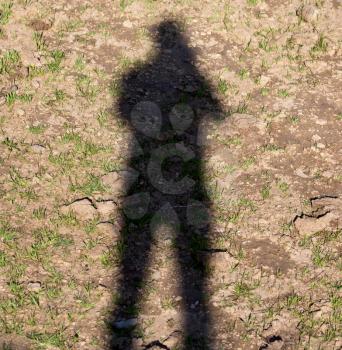 Man's shadow on the ground in nature