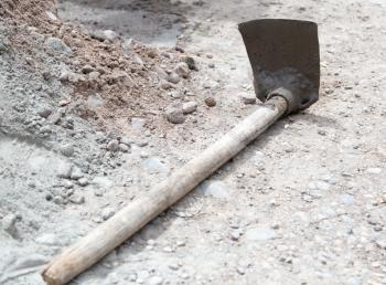 Shovel on a mixture of concrete at the construction site .