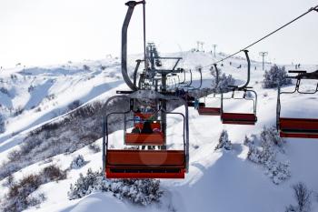 Ski lift in the mountains in winter .