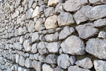 Wall made of granite stones as background .