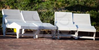 White seating for relaxation near the pool