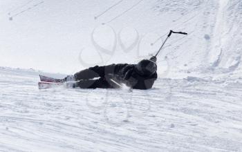 The skier fell in the snow at speed .