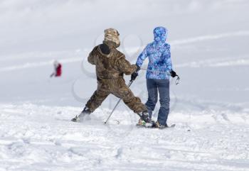 Two skier skiing in the snow in winter .