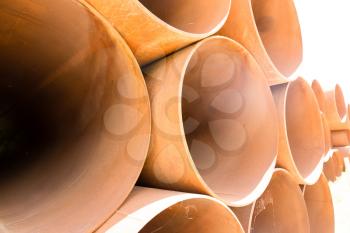 large rusty metal pipes as a background .
