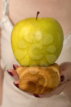 Healthy lifestyle dilemma - apple or croissant