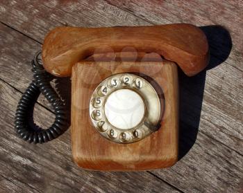 Wooden telephone on wooden background