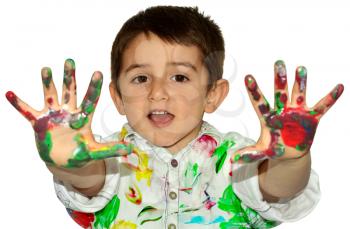 Little boy painting with hands with different color paint on his palms