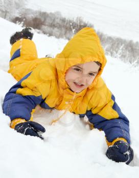 Cute little boy playing in the snow