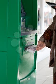 Royalty Free Photo of a Woman Using a Bank Machine
