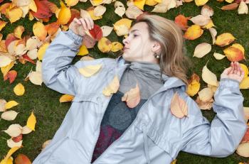 Royalty Free Photo of a Woman Laying in Leaves